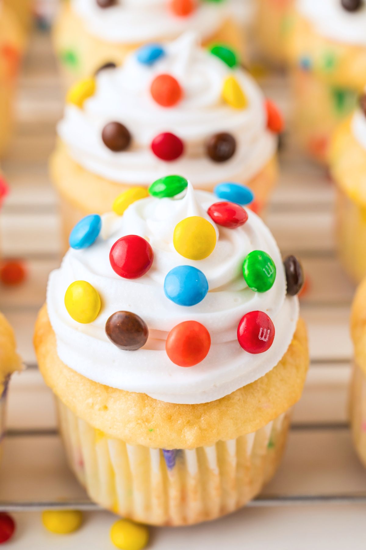 Funfetti cupcakes filled with m and m's, then topped with vanilla frosting and more candies. 