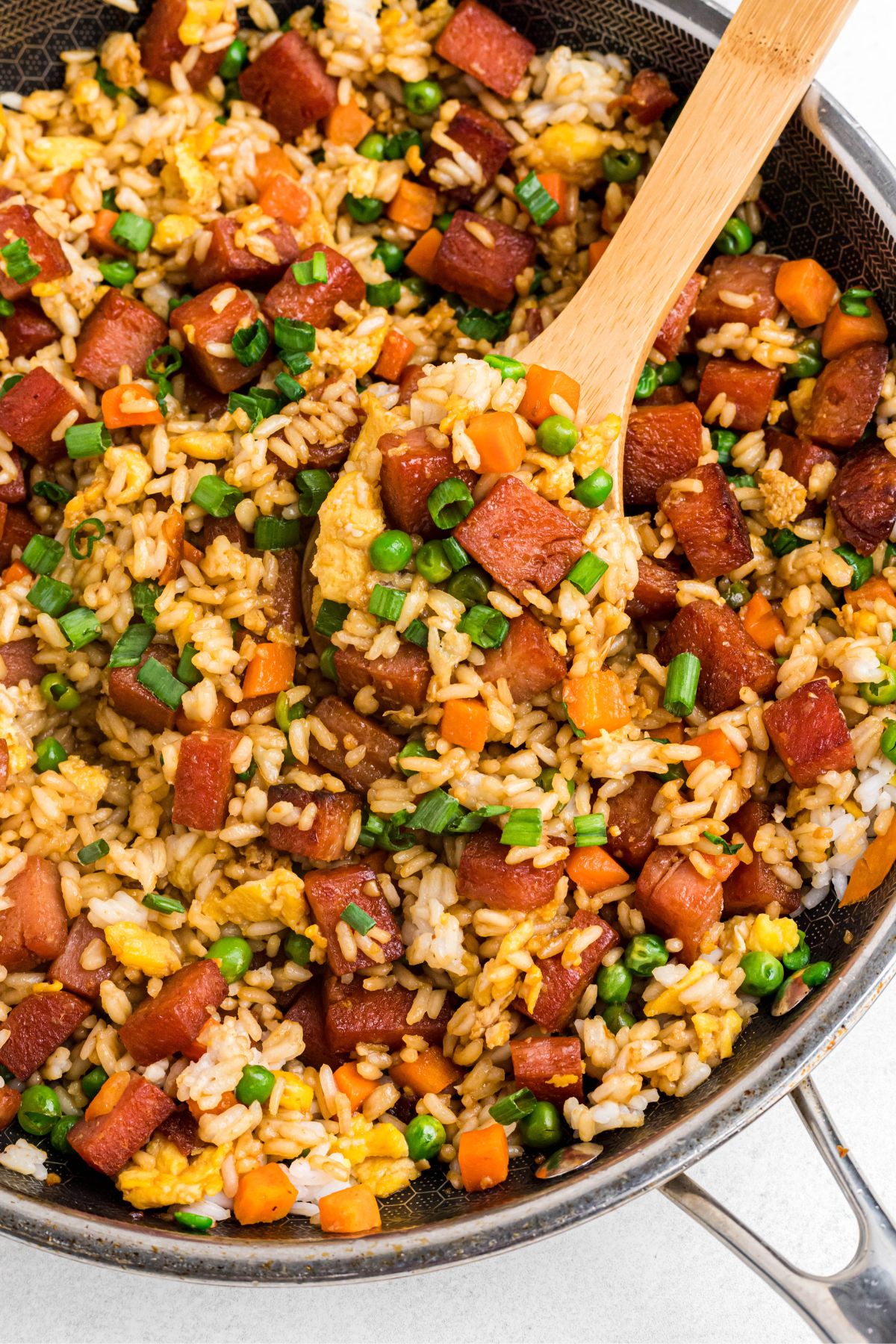 Rice and spam with other ingredients, cooked and mixed in a large skillet. 