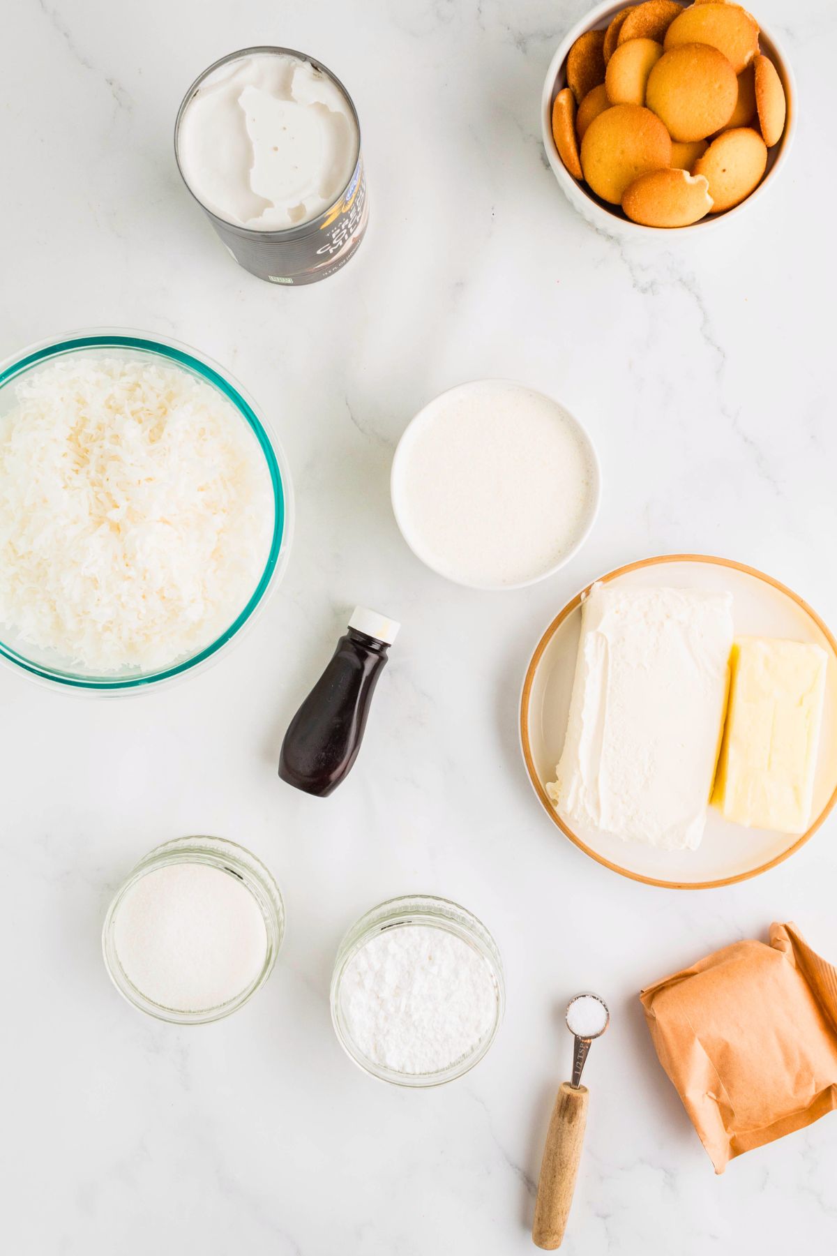 Ingredients needed to make coconut delight measured in small bowls. 