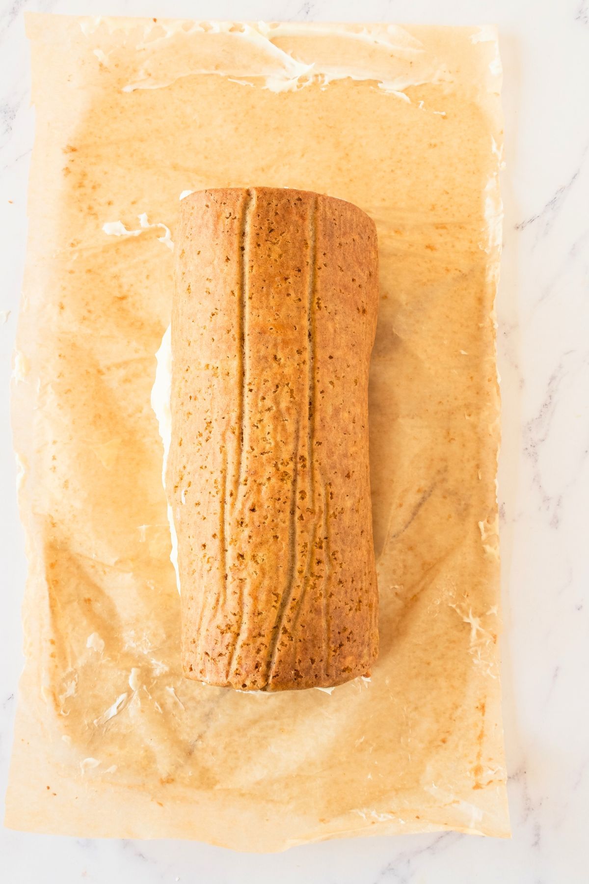 Carrot cake rolled after having cream cheese filling on inside. 