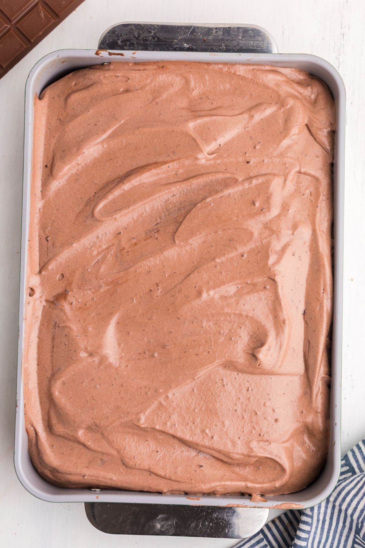 Chocolate cake frosted with chocolate whipped cream topping.