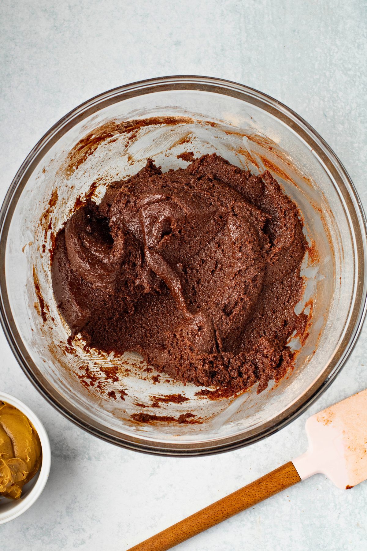 Brownie batter mixed together in a large glass mixing bowl. 