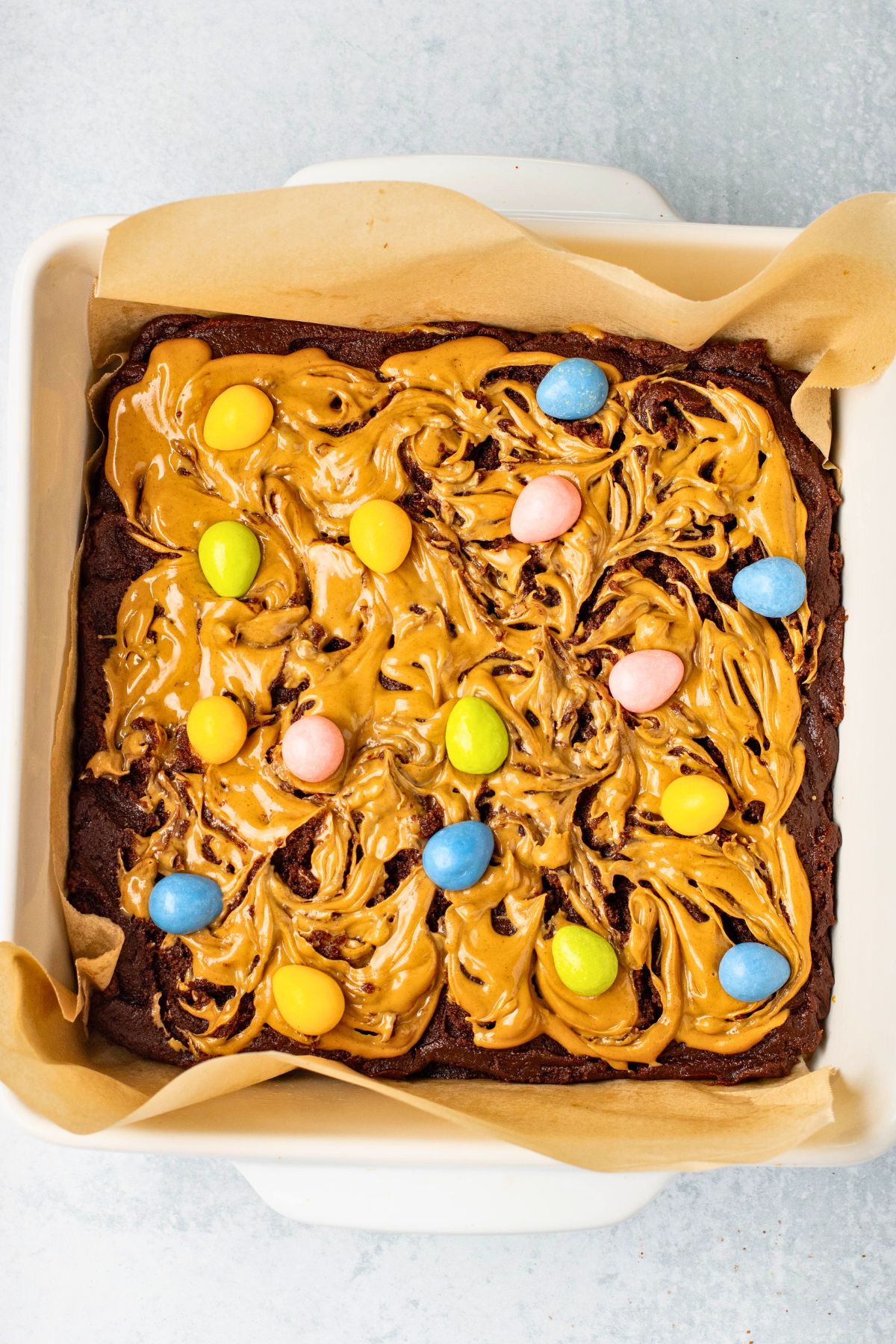 Brownie batter topped with peanut butter batter, then topped with candy eggs. 