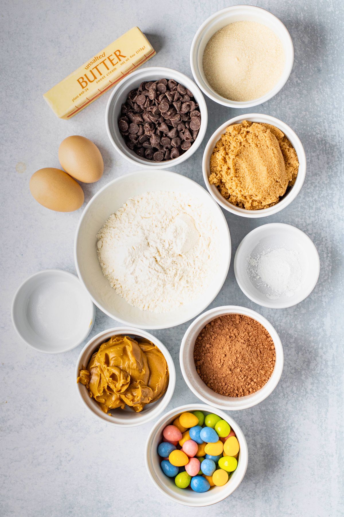 Ingredients needed to make Easter brownies measured into small white bowls. 