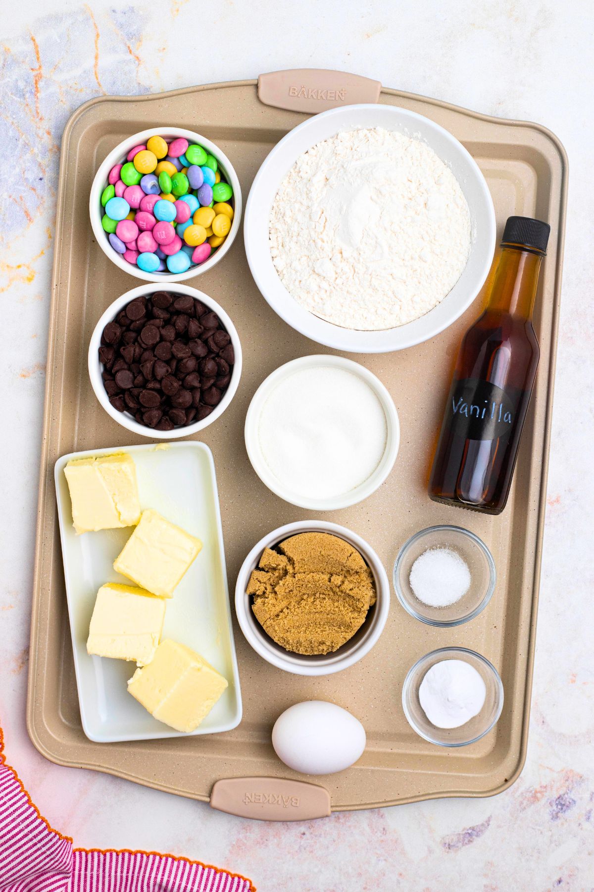 Ingredients needed to make Easter chocolate chip cookies measured and placed on a baking sheet.