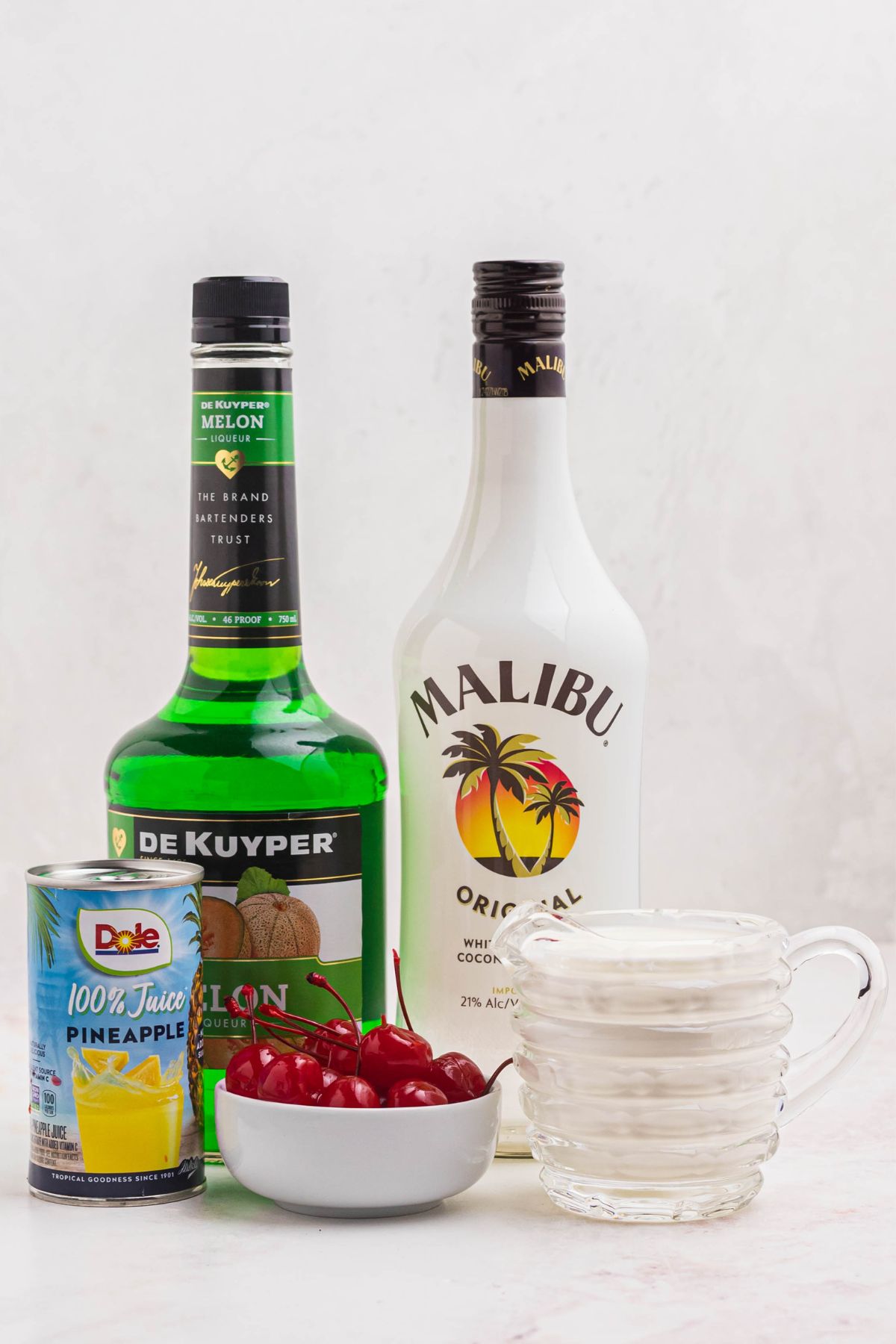 Ingredients needed to make scooby snack shots on a marble table. 