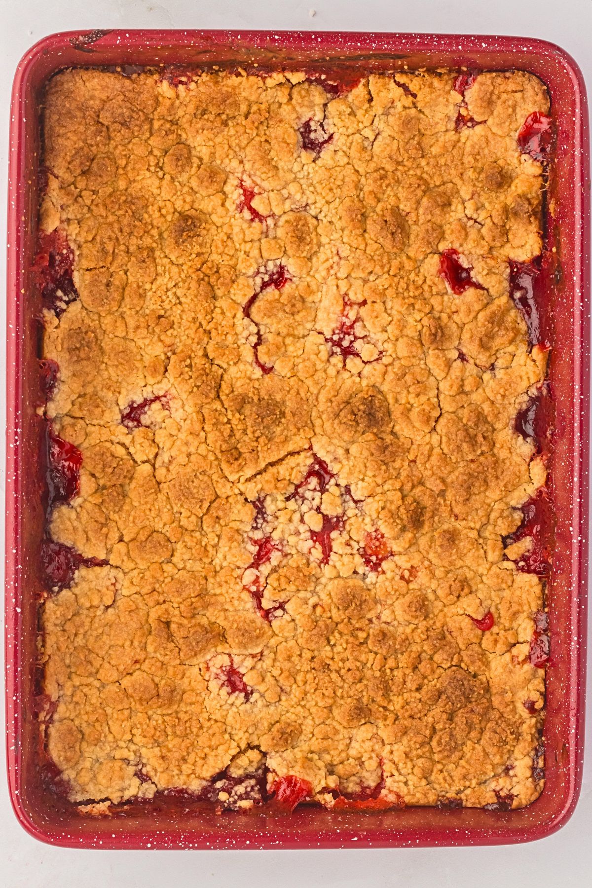 Golden and bubbly dump cake in a baking pan. 