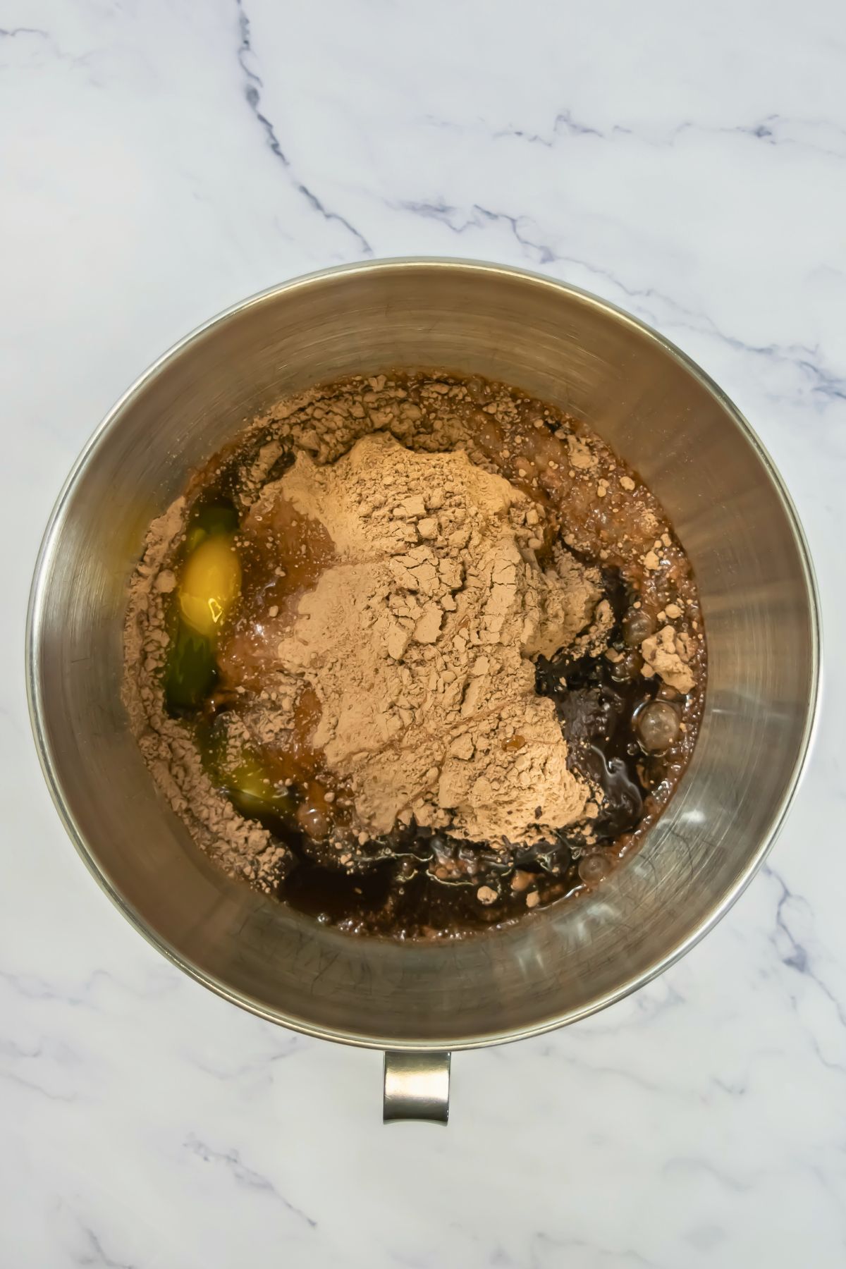 Chocolate cake mix in the stand mixer bowl before being mixed with other ingredients. 