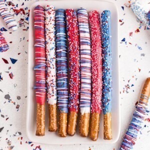 Dipped pretzel rods in red, white, and blue colors with sprinkles.