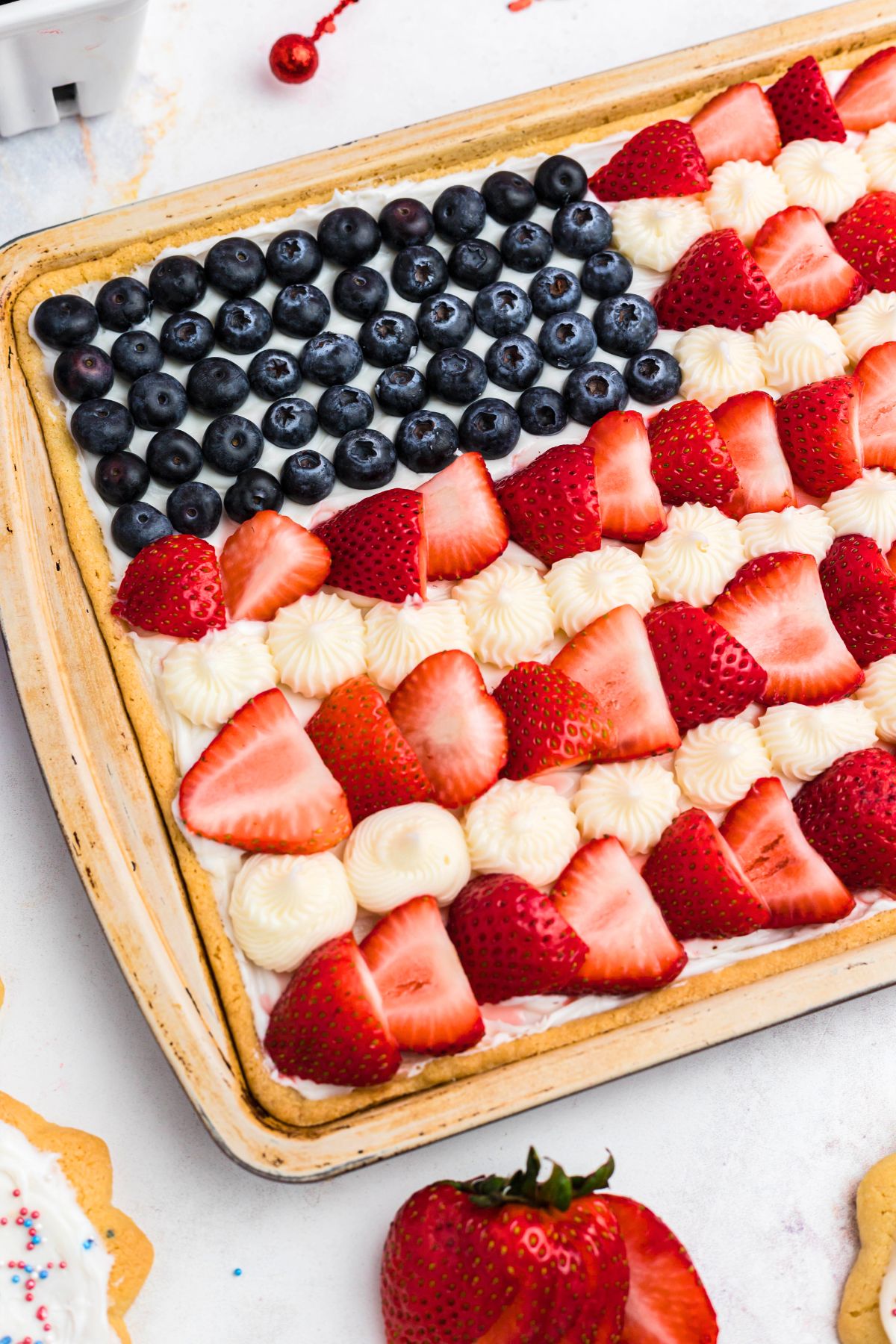 Fruit and frosting, decorating cookie, with berries on the table. 