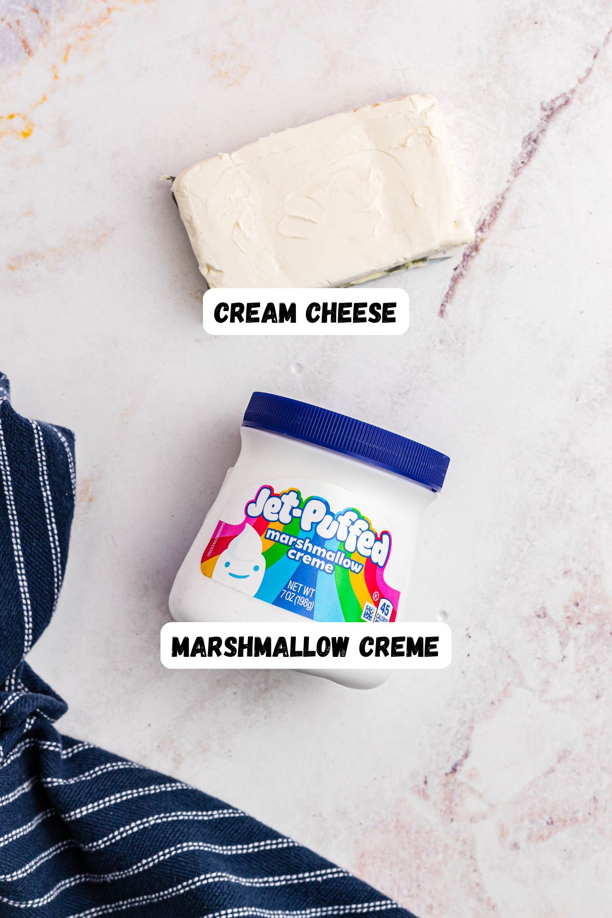 Marshmallow creme and cream cheese on a marble table. 
