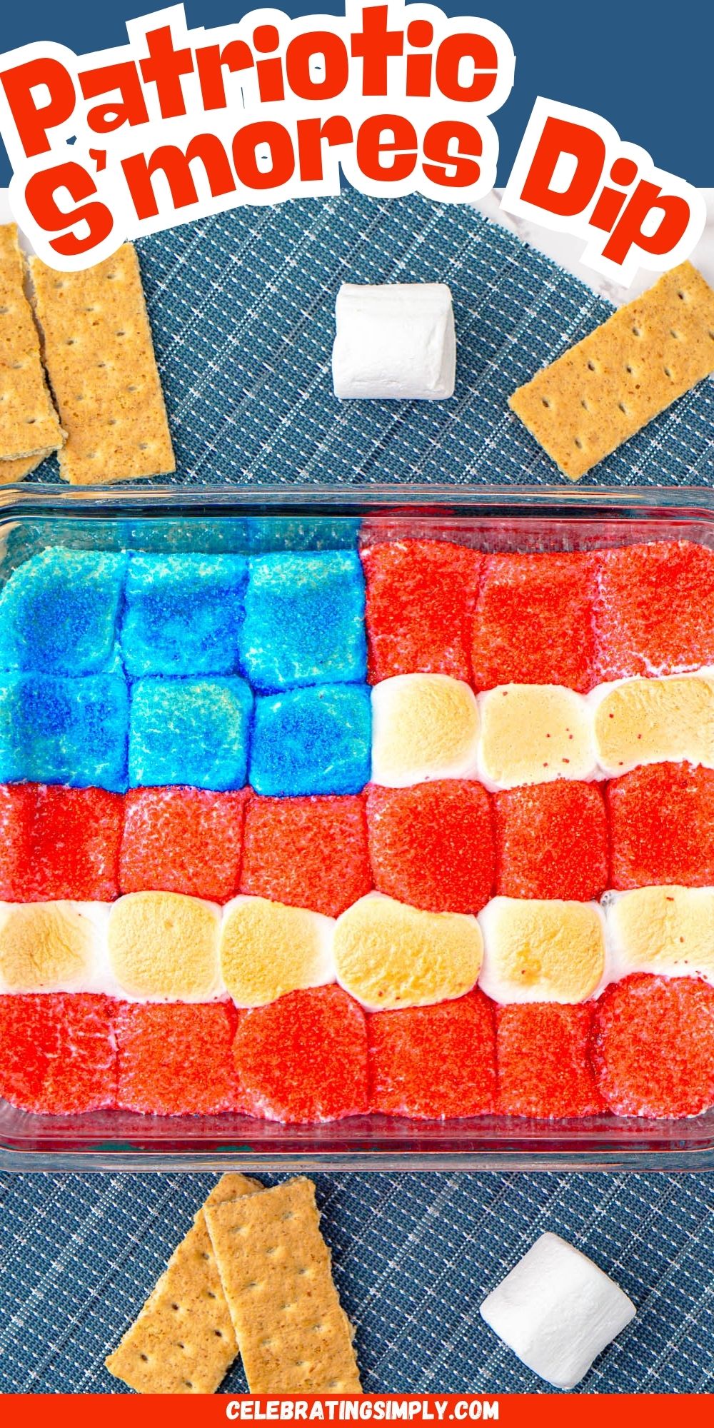 Red white and blue marshmallows over chocolate in a clear baking dish with graham crackers on the table for dipping.