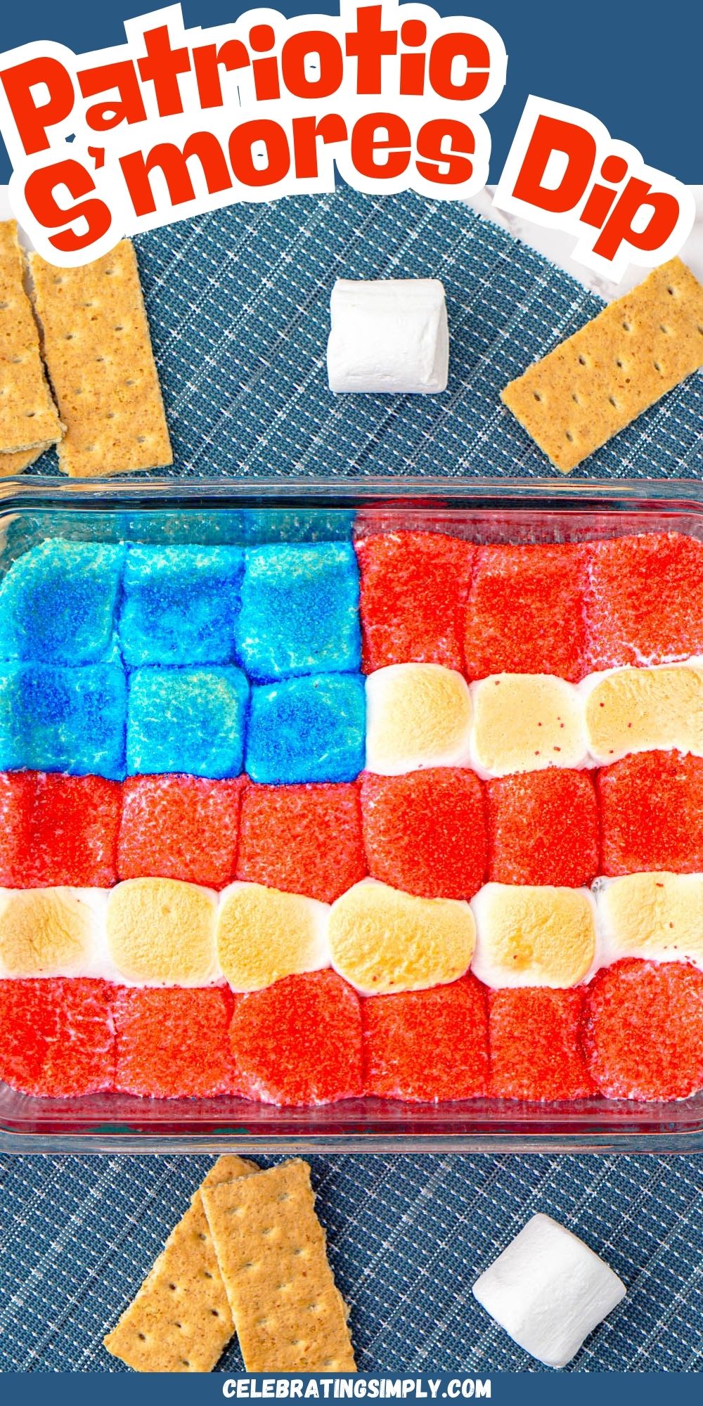 Red white and blue marshmallows over chocolate in a clear baking dish with graham crackers on the table for dipping.