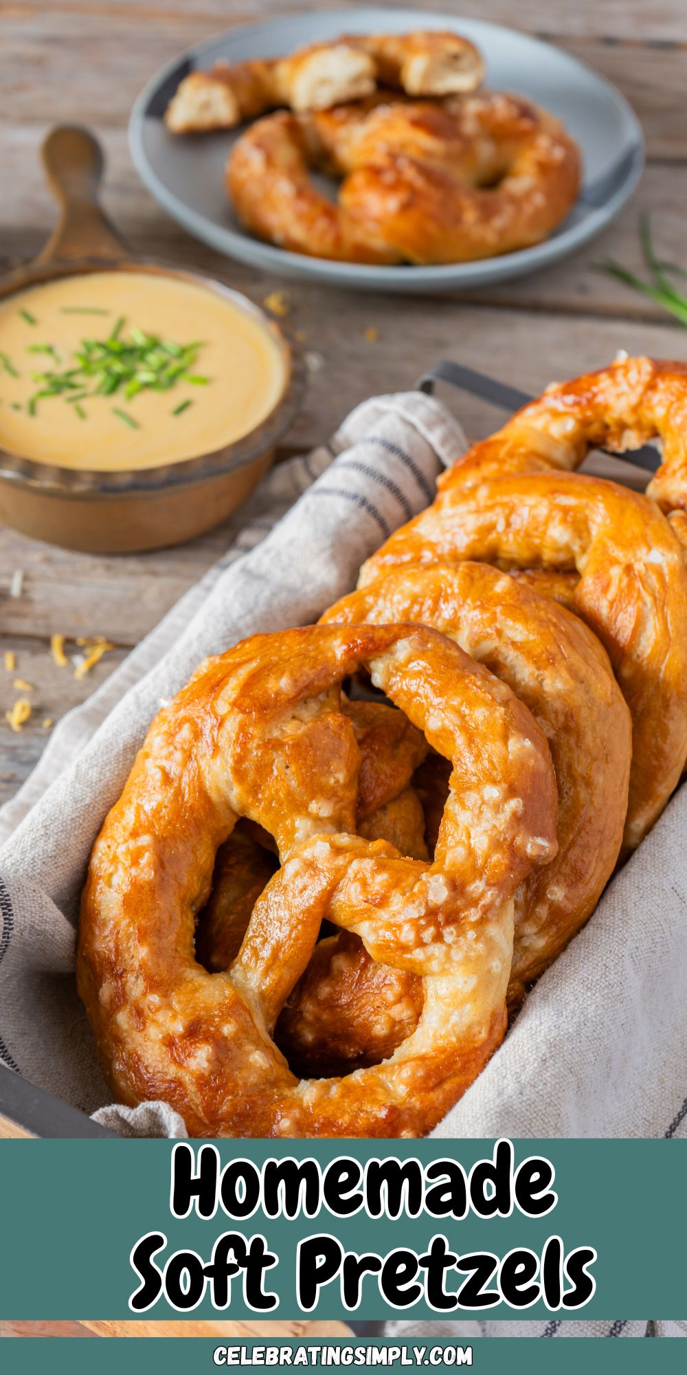 Golden baked soft pretzels stacked in a bread box, in front of cheese dip.
