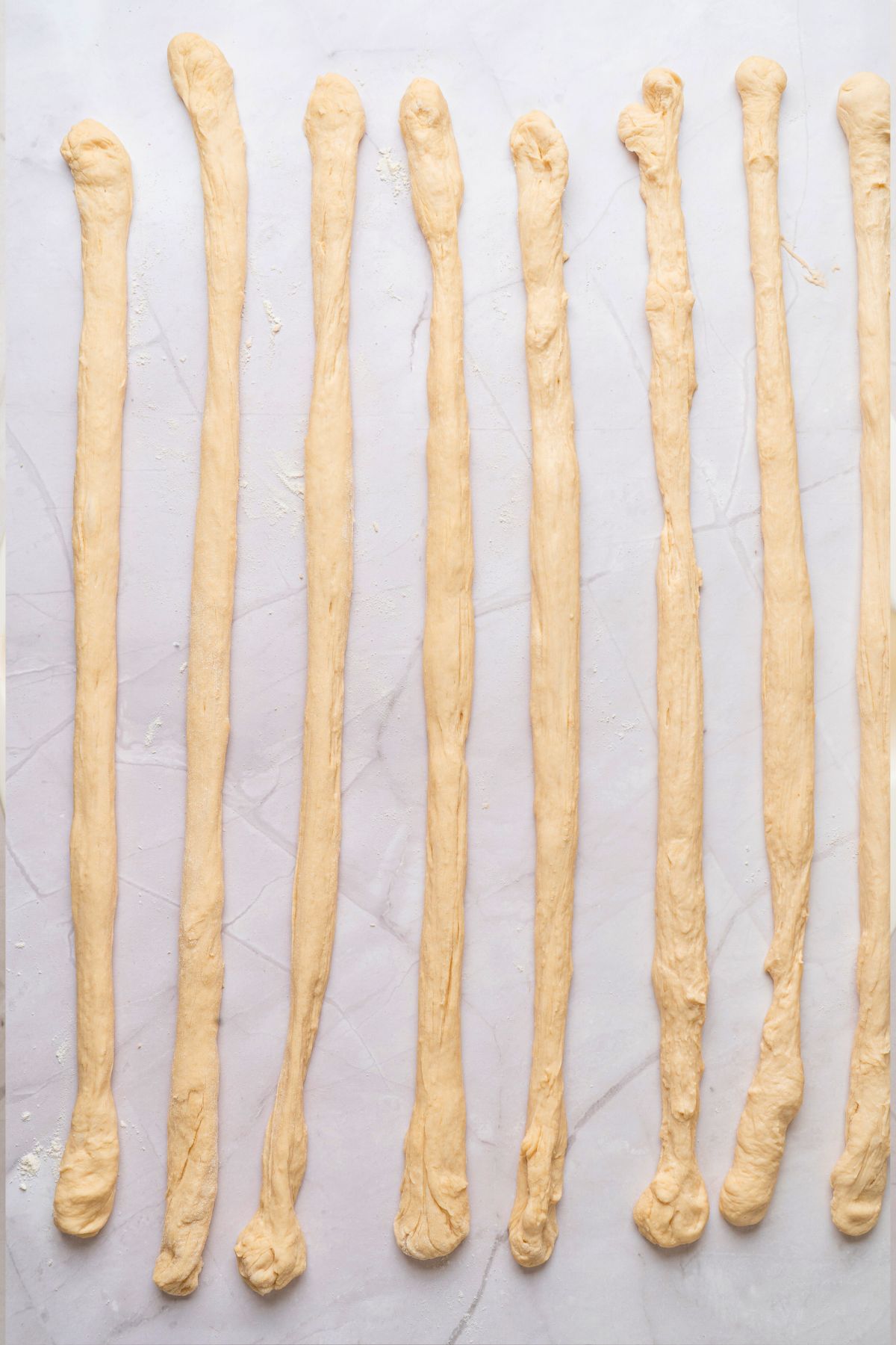 Pretzel dough divided into strips and rolled into 8 pieces, about 24 inches long. 