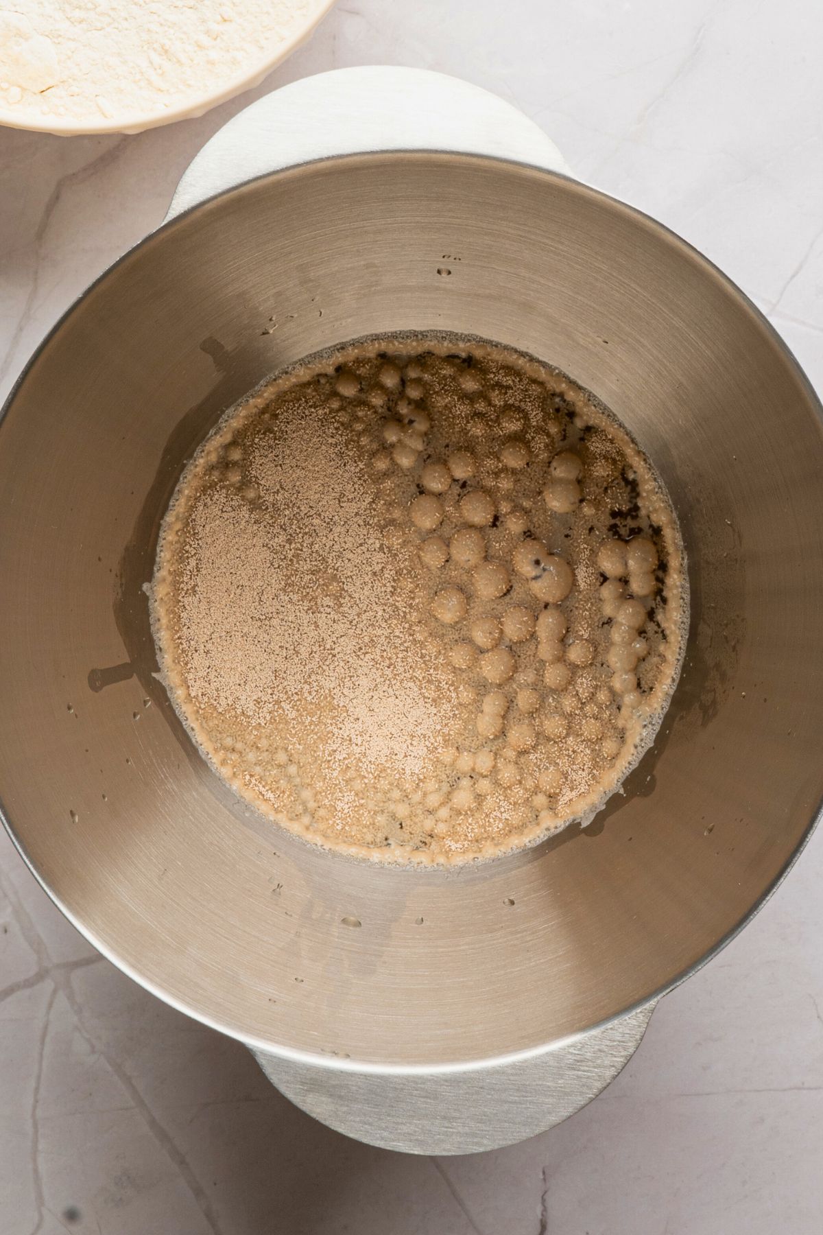 Yeast activating in warm beer, in a silver bowl. 