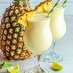 Soft yellow slushie drink of virgin pina colada in a glass.