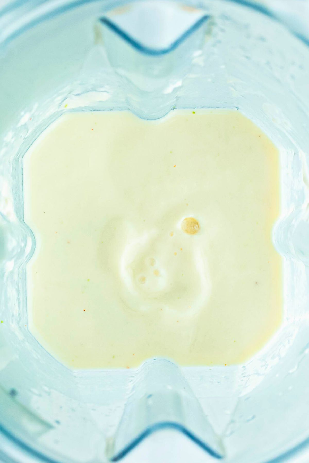 Creamy blend of juice and frozen pineapple, blended together in a blender. 