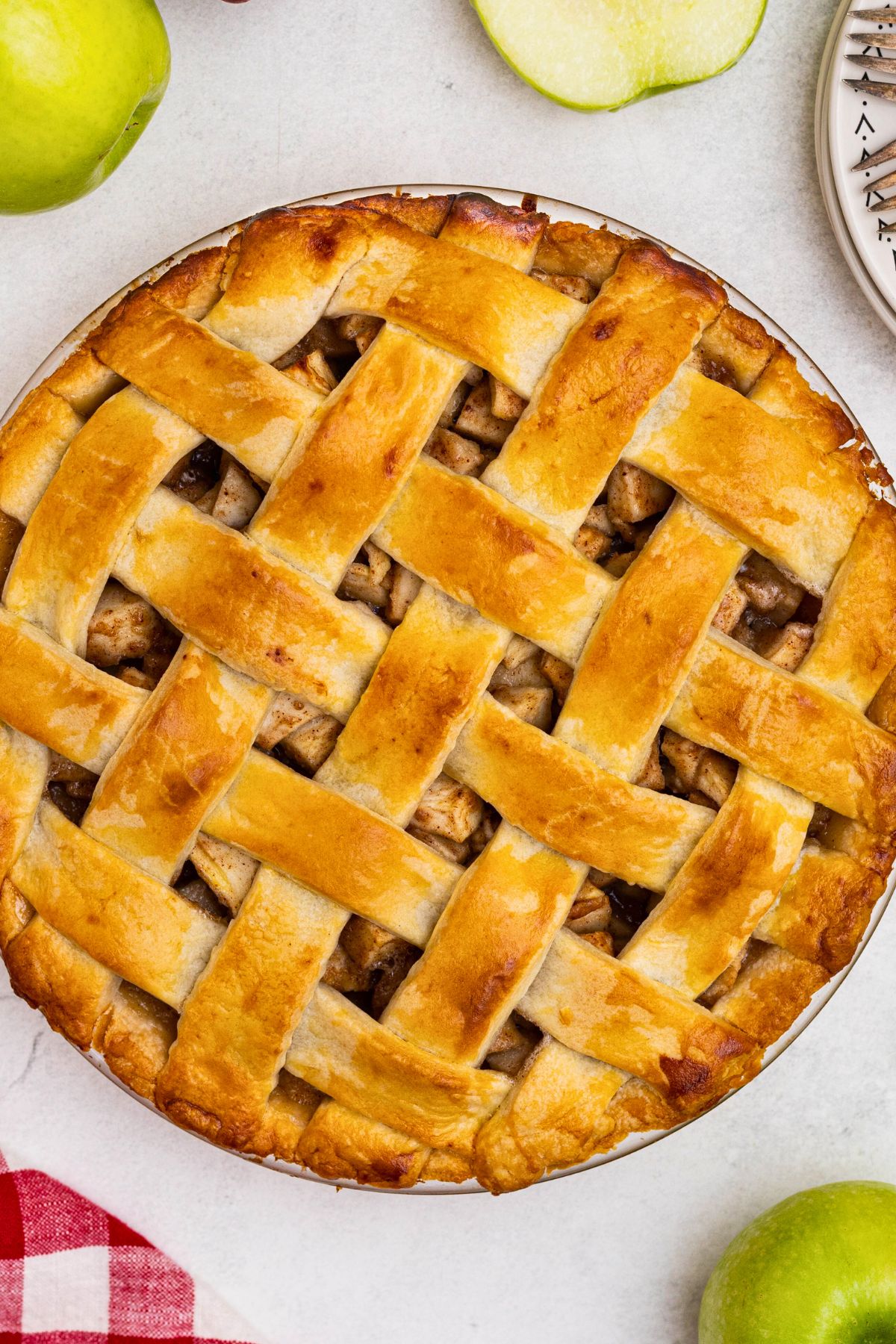 Golden baked apple pie on a white marble table. 