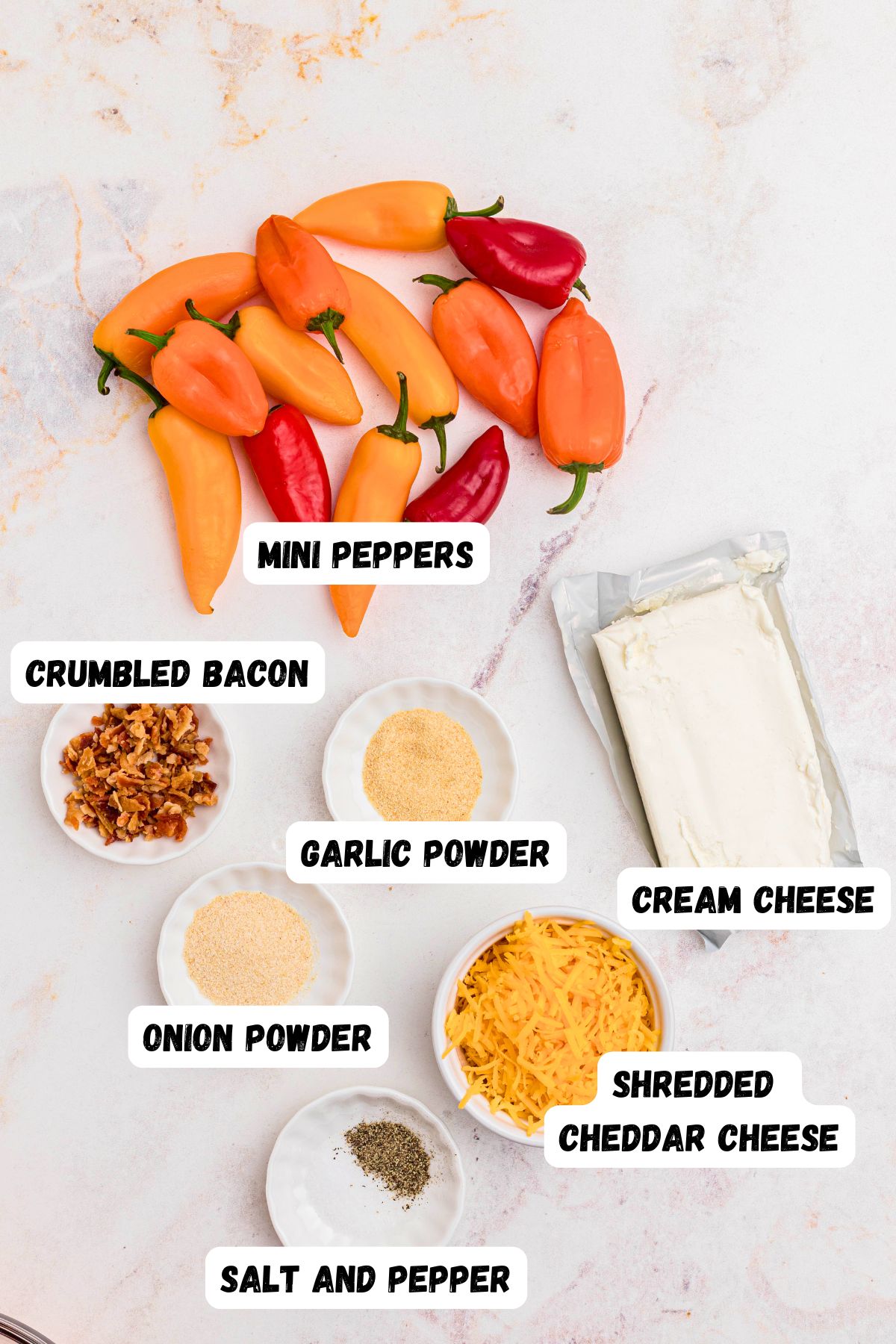 Ingredients needed to make stuffed peppers, measured in small bowls on a marble table.