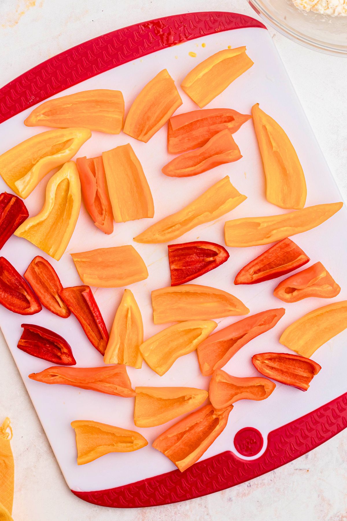 Red, yellow, and orange small peppers cut in half and seeds cleaned out.
