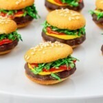 Wafer cookies with frosting, shredded coconut, and icing in between so they look like a hamburger.