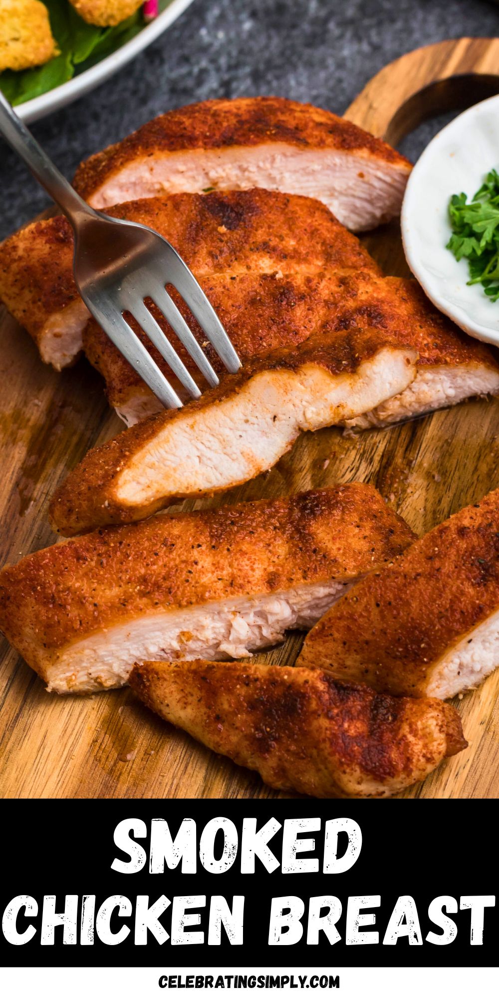Smoked, seasoned chicken on a small, round cutting board, with parsley flakes in a small cutting board.
