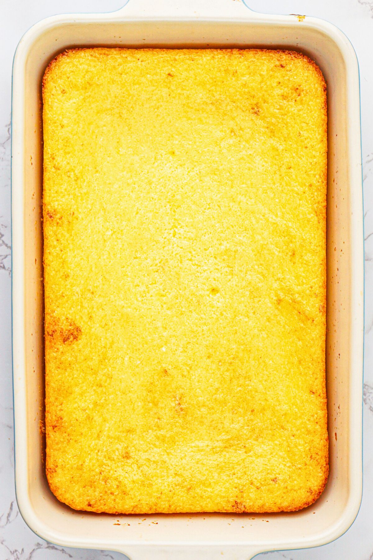 Lemon cake mix and pie filling in pie dish after they have been mixed and baked in a 9x13 baking dish. 