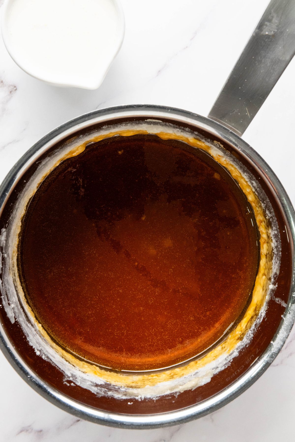 Melted sugar with butter and vanilla added, in a large saucepan. 