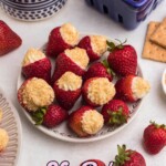 Cheesecake stuffed strawberries on a marble table.