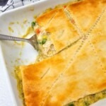 Golden crusted chicken pot pie casserole in baking dish after baking in the oven.