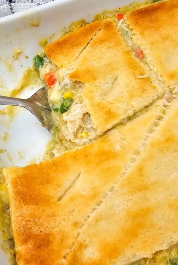 Golden crusted chicken pot pie casserole in baking dish after baking in the oven.