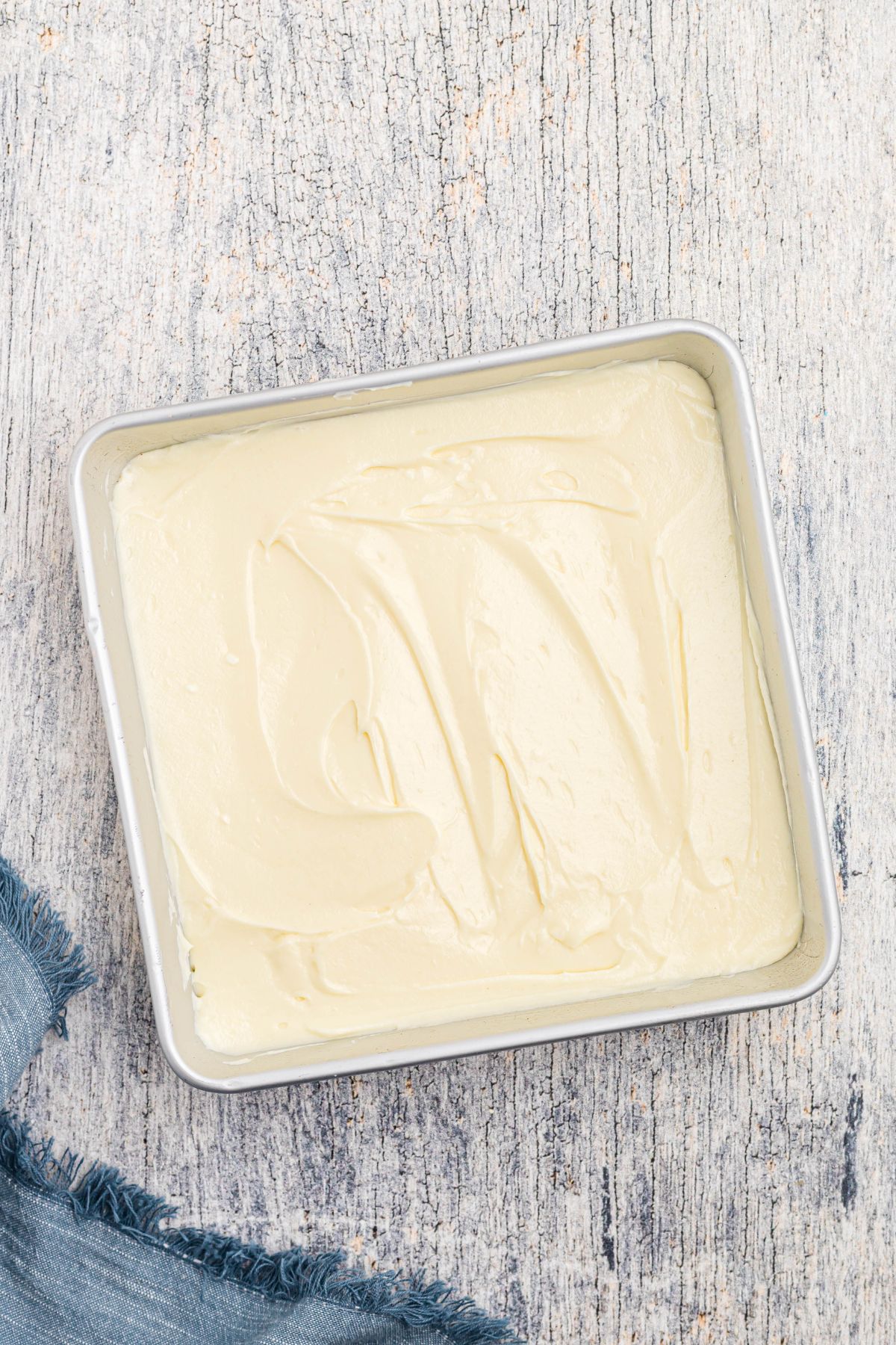 Cheesecake filling spread evenly in an 8x8 baking pan. 