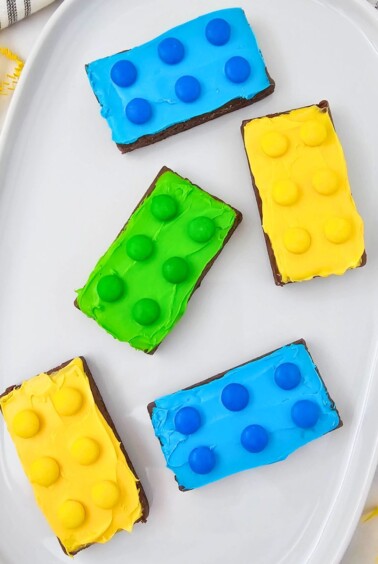 Bright and colorful brownies, frosted and topped with matching candies.