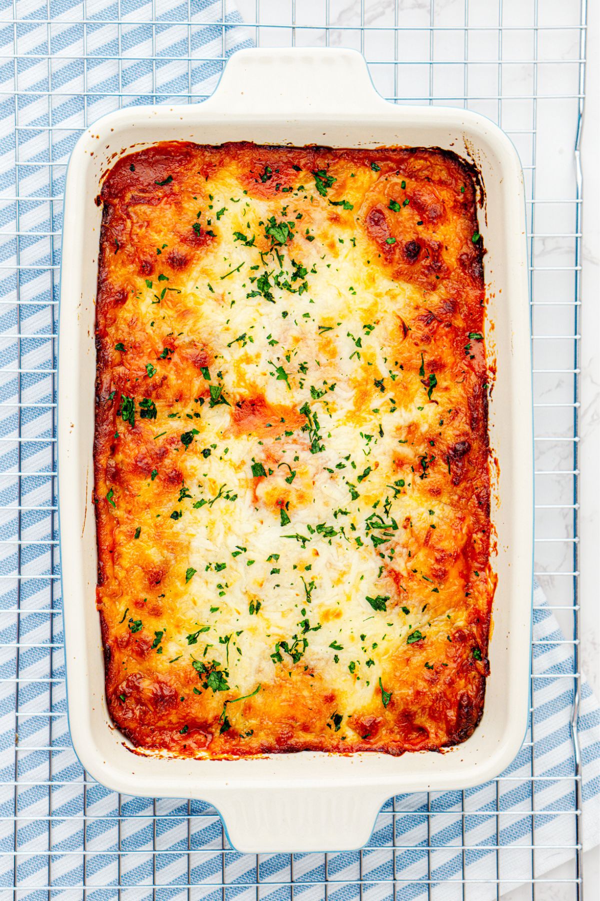 baked casserole dish filled with layers of ravioli, cheese, and sauce, after it's been baked. 