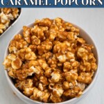 Golden caramel popcorn in a white bowl with pieces of popcorn scattered around the bowl.