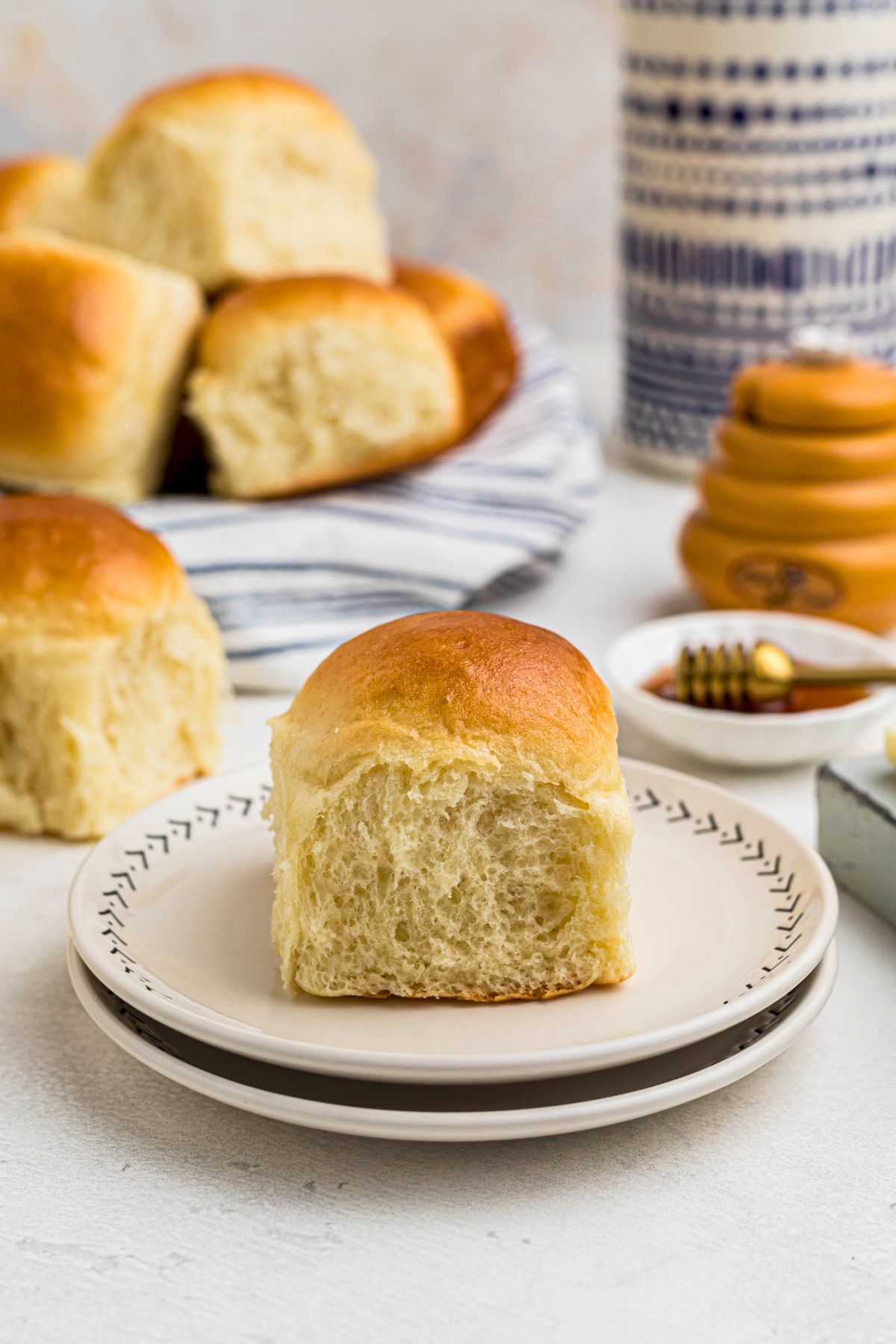 Golden baked roll on a small white plate