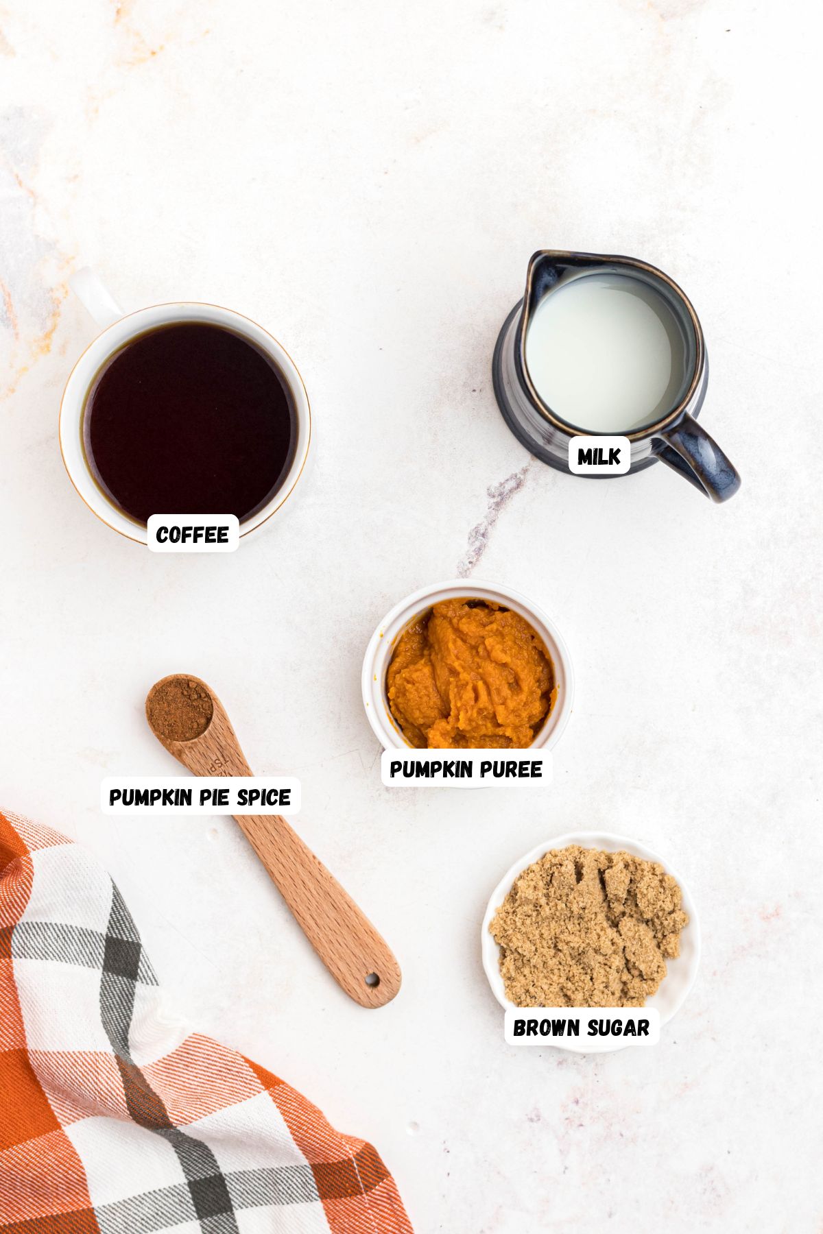Ingredients you will need to make pumpkin coffee measured into small bowls and labeled, 
