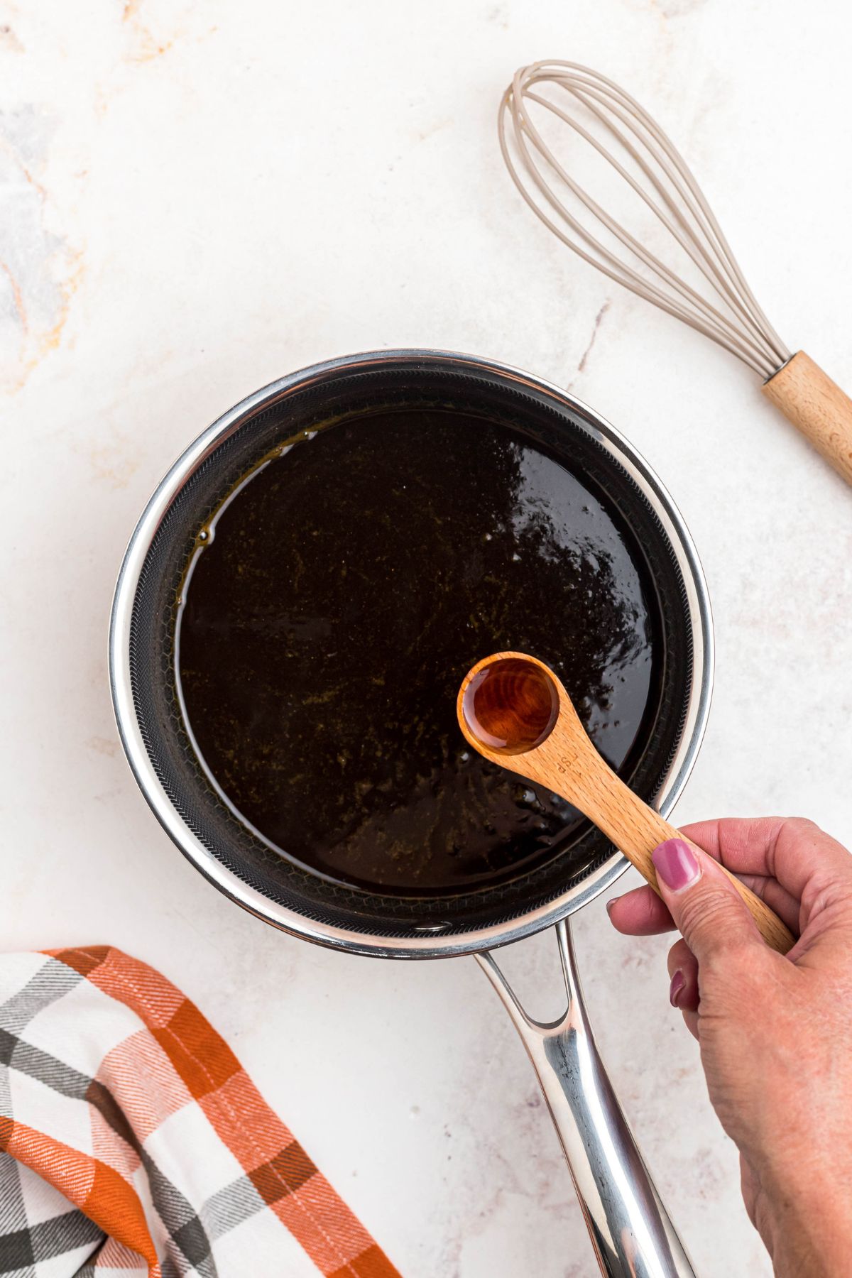 Vanilla extract being added to saucepan. 