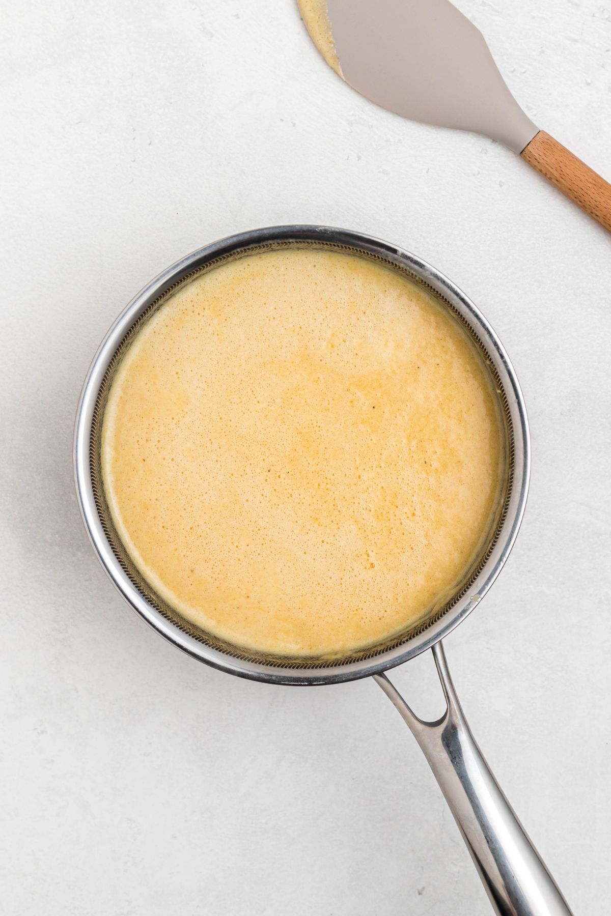 Melted cheeses, mixed with milk, cream, and seasonings, in a medium saucepan. 