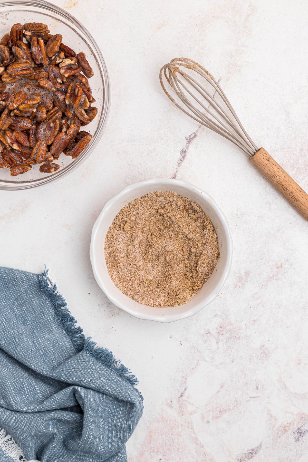 Sugars and other ingredients mixed in a small white bowl. 