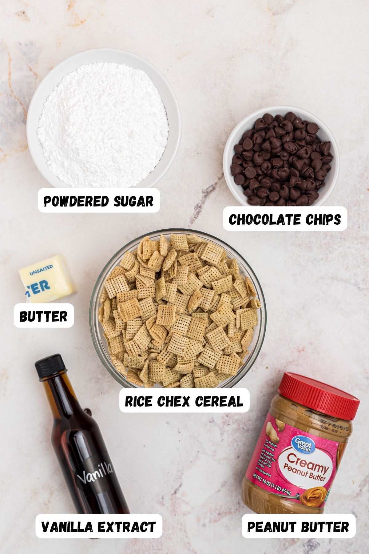 Ingredients needed to make puppy chow measure into small bowls and labeled on marble table. 