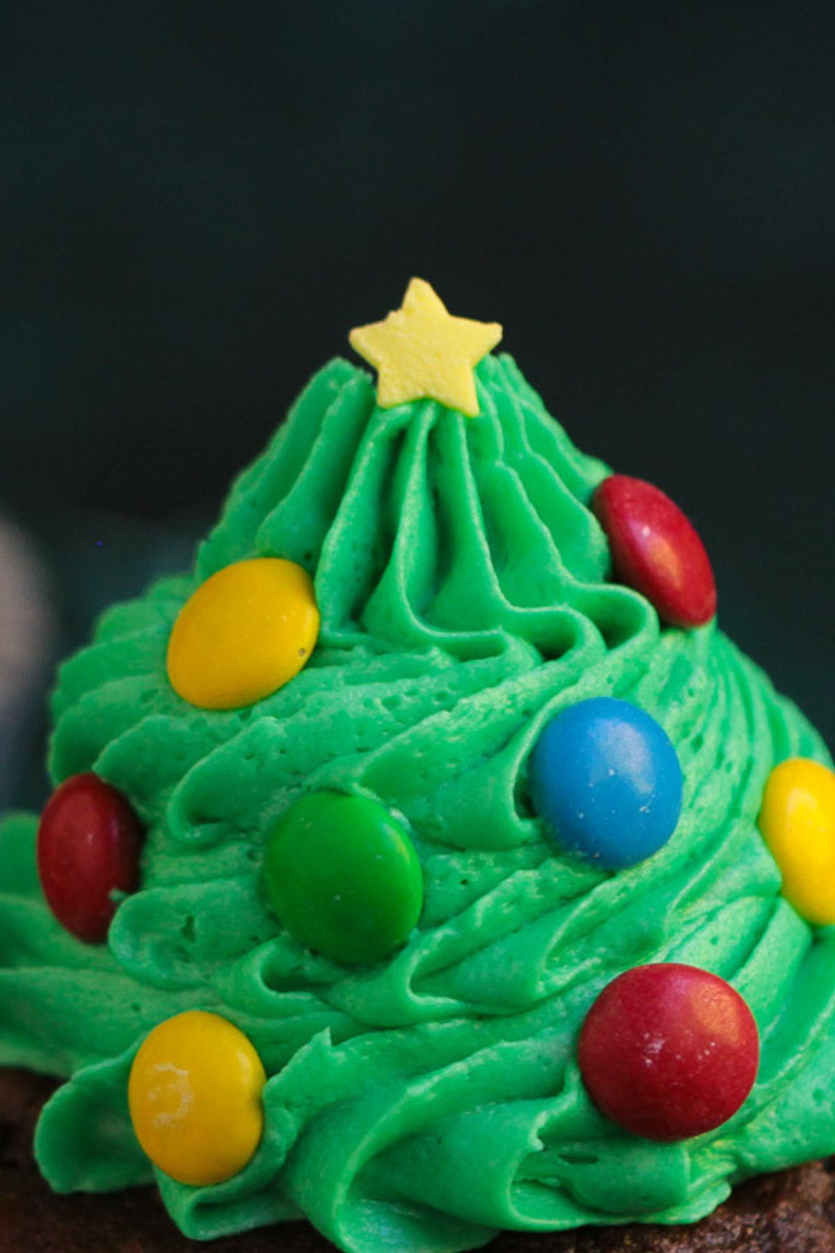 Candy star sprinkles used as tree toppers on frosting trees.