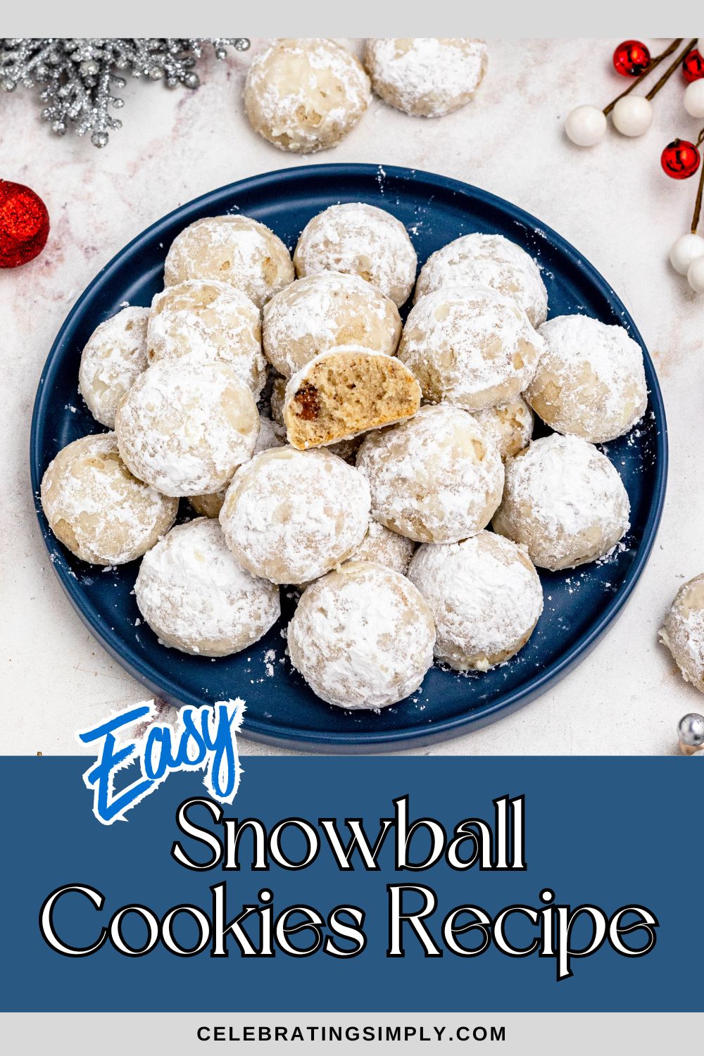 Powder sugar coated Snowball cookies, stacked on a blue plate with holiday party favors on the table around the plate.