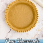 Golden pie crust, rolled into pie plate, with edges fluted.