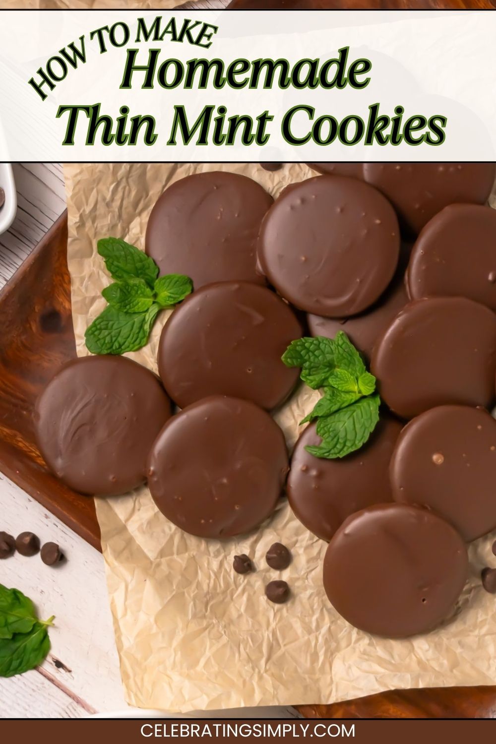 Thin chocolate coated cookies, on brown parchment paper, with a few mint leaves on the paper with the cookies.