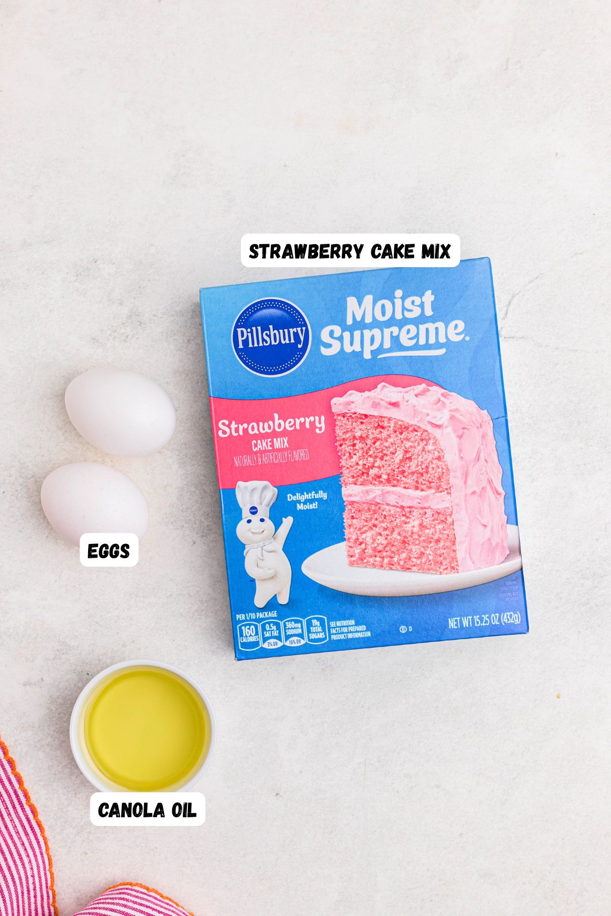 Ingredients needed to make cake mix cookies on a marble table labeled.