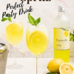 Glass of yellow limoncello spritz, topped with a sprig of mint and a lemon slice garnish.