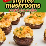 Brown mushrooms topped with cream cheese mixture and breadcrumbs, on a white plate.