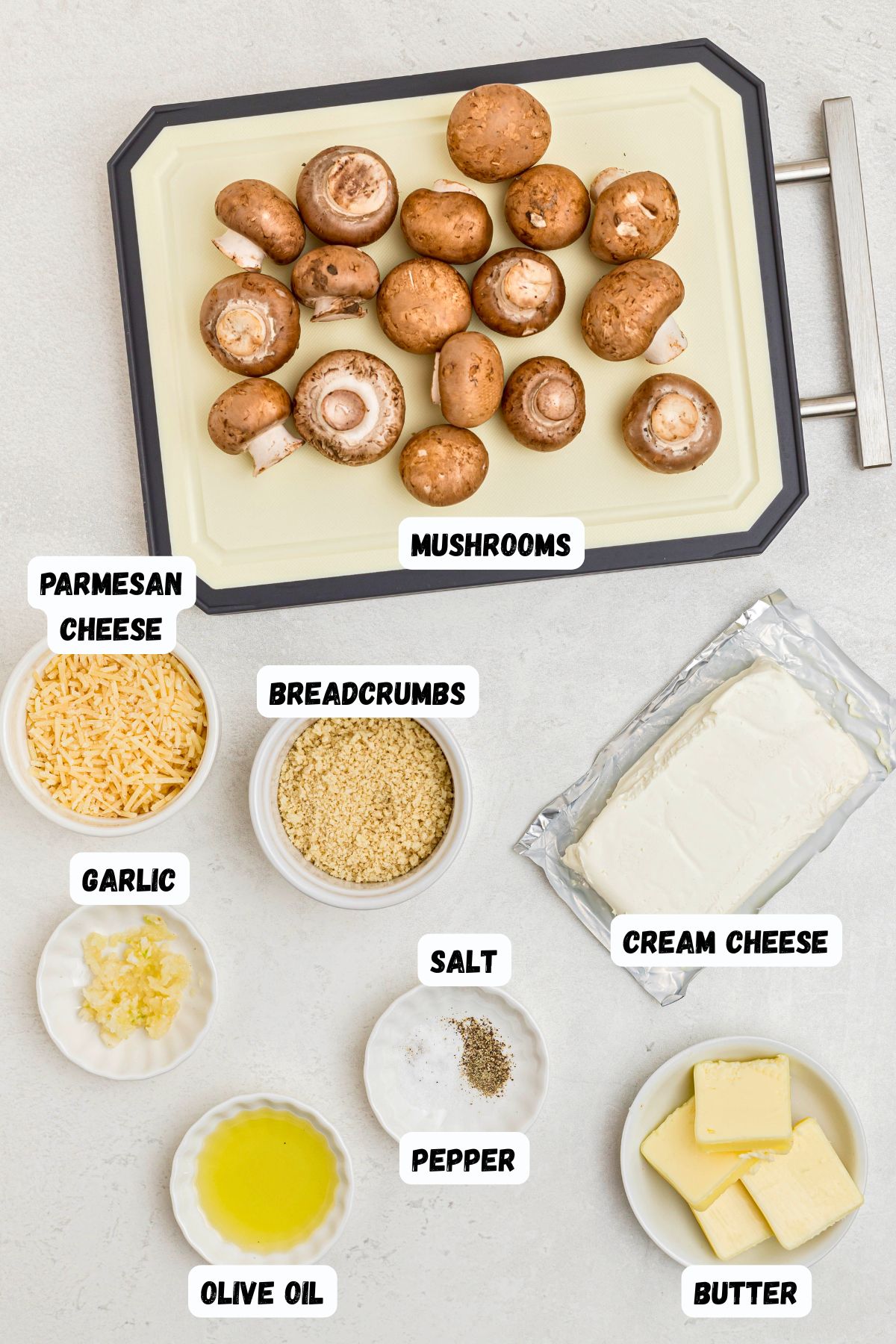 Ingredients measured out in small dishes, and labeled, on a white marble table. 